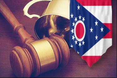 Flag with Ohio state symbol, gold trophy, and judge's gavel